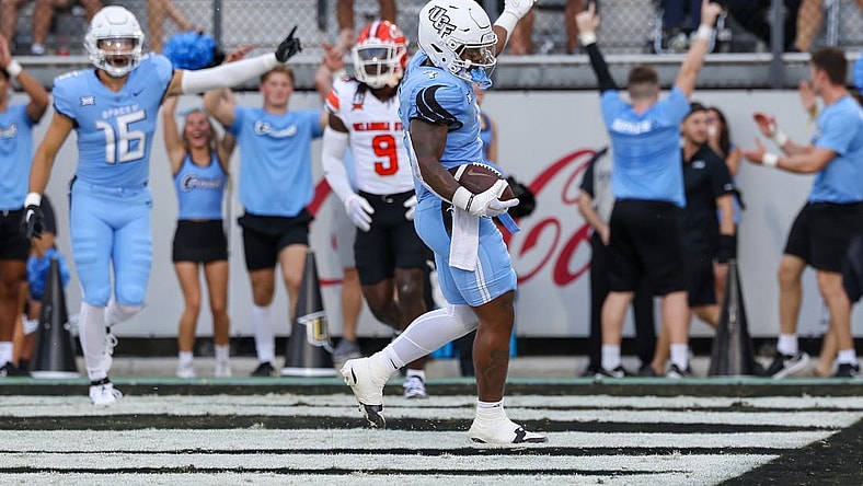 Nov 11, 2023; Orlando, Florida, USA; UCF Knights running back RJ Harvey (7) celebrates after scoring a touchdown during the first quarter against the Oklahoma State Cowboys at FBC Mortgage Stadium. Mandatory Credit: Mike Watters-USA TODAY Sports