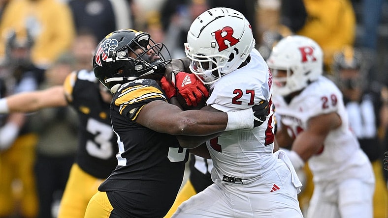 Nov 11, 2023; Iowa City, Iowa, USA; Iowa Hawkeyes linebacker Jay Higgins (34) tackles Rutgers Scarlet Knights running back Samuel Brown V (27) during the second quarter at Kinnick Stadium. Mandatory Credit: Jeffrey Becker-USA TODAY Sports