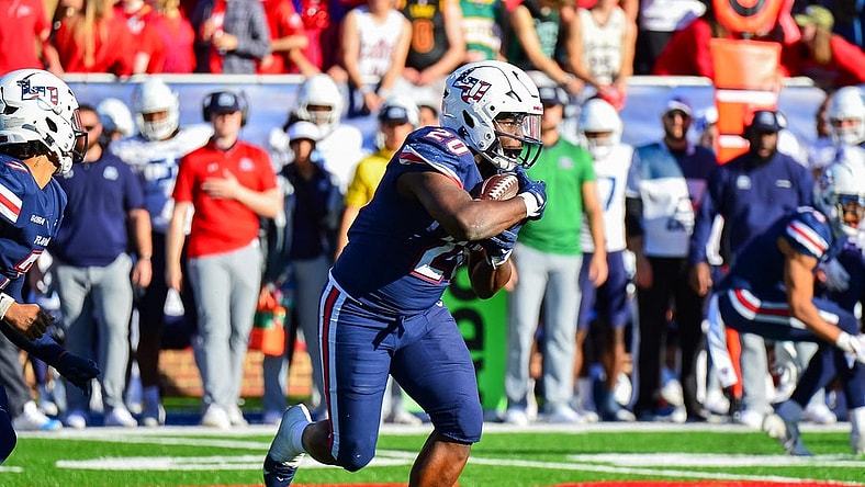 Nov 11, 2023; Lynchburg, Virginia, USA;  Liberty Flames running back Quinton Cooley (20) runs the ball in the third quarter at Williams Stadium. Mandatory Credit: Brian Bishop-USA TODAY Sports