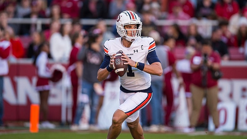 Nov 11, 2023; Fayetteville, Arkansas, USA;  Auburn Tigers quarterback Payton Thorne (1) rolls out to pass during the second quarter against the Arkansas Razorbacks at Donald W. Reynolds Razorback Stadium. Mandatory Credit: Brett Rojo-USA TODAY Sports