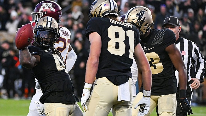 Nov 11, 2023; West Lafayette, Indiana, USA;  Purdue Boilermakers wide receiver Deion Burks (4) celebrates with tight end George Burhenn (81) and wide receiver Jaron Tibbs (13) after scoring a touchdown against the Minnesota Golden Gophers during the second half at Ross-Ade Stadium. Mandatory Credit: Robert Goddin-USA TODAY Sports