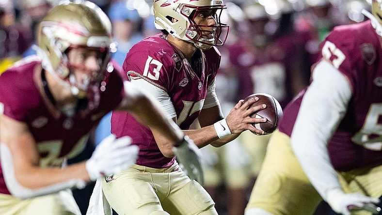 Florida State Seminoles quarterback Jordan Travis (13) looks to pass to his teammate. The Florida State Seminoles defeated the Miami Hurricanes 27-20 on Saturday, Nov. 11, 2023.