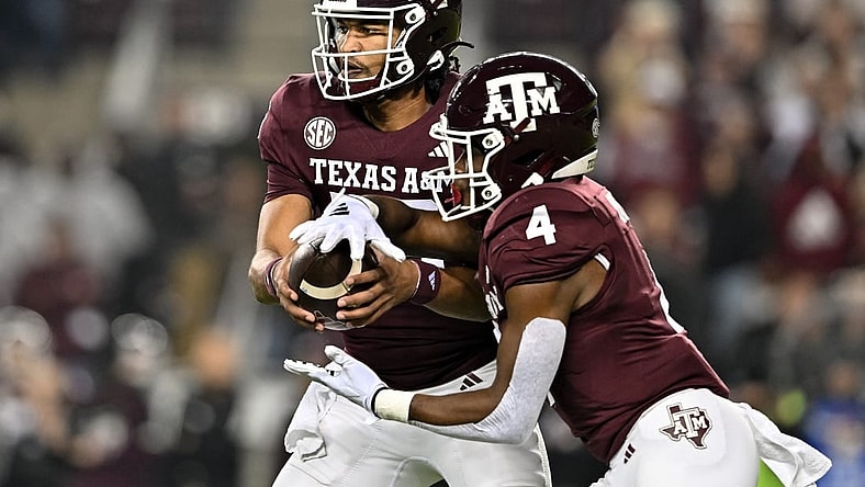 Nov 11, 2023; College Station, Texas, USA; Texas A&M Aggies quarterback Jaylen Henderson (16) hands off the ball to running back Amari Daniels (4) during the first quarter at Kyle Field. Mandatory Credit: Maria Lysaker-USA TODAY Sports