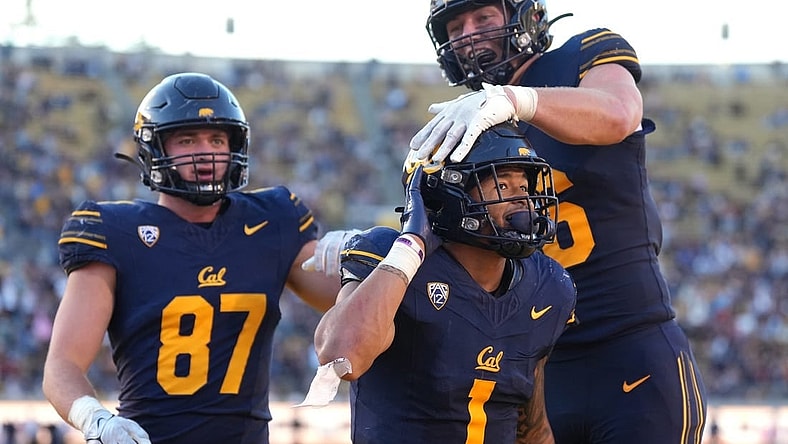 Nov 11, 2023; Berkeley, California, USA; California Golden Bears running back Jaydn Ott (1) gestures towards the Washington State Cougars fan section after scoring a touchdown while being congratulated by tight end Jeffrey Johnson (right) and tight end Jack Endries (87) during the fourth quarter at California Memorial Stadium. Mandatory Credit: Darren Yamashita-USA TODAY Sports