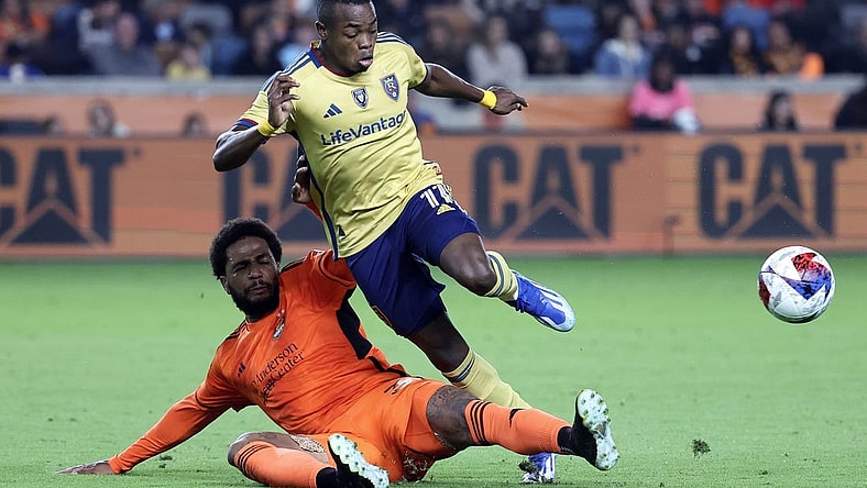 Nov 11, 2023; Houston, Texas, USA; Real Salt Lake forward Carlos Andres Gomez (11) and Houston Dynamo defender Micael (31) battle for the ball during the second half at Shell Energy Stadium. Mandatory Credit: Troy Taormina-USA TODAY Sports
