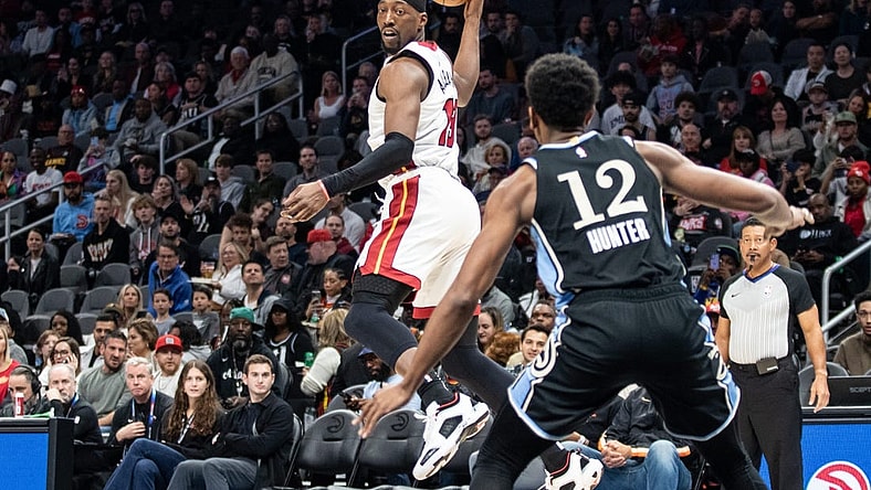 Nov 11, 2023; Atlanta, Georgia, USA; Miami Heat center Bam Adebayo (13) saves the ball from going out of bounds against Atlanta Hawks forward De'Andre Hunter (12) during the first quarter at State Farm Arena. Mandatory Credit: Jordan Godfree-USA TODAY Sports
