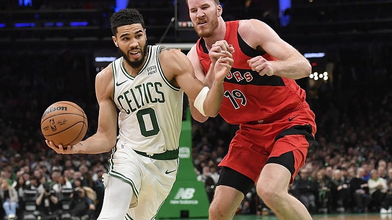 Nov 11, 2023; Boston, Massachusetts, USA;  Boston Celtics forward Jayson Tatum (0) drives to the basket past Toronto Raptors center Jakob Poeltl (19) during the first half at TD Garden. Mandatory Credit: Bob DeChiara-USA TODAY Sports
