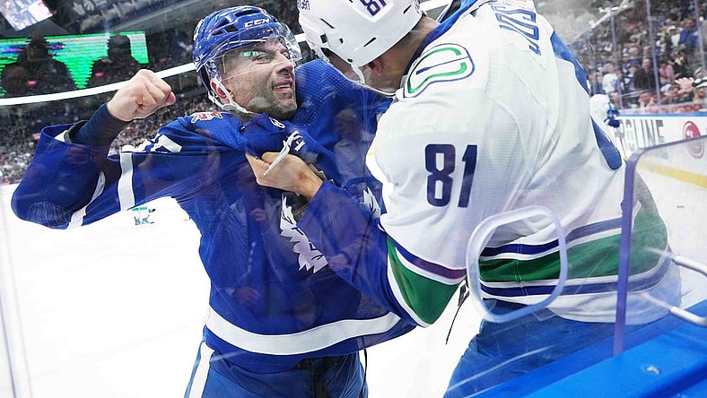 Nov 11, 2023; Toronto, Ontario, CAN; Toronto Maple Leafs defenseman Mark Giordano (55) fights with Vancouver Canucks center Dakota Joshua (81) during the first period at Scotiabank Arena. Mandatory Credit: Nick Turchiaro-USA TODAY Sports