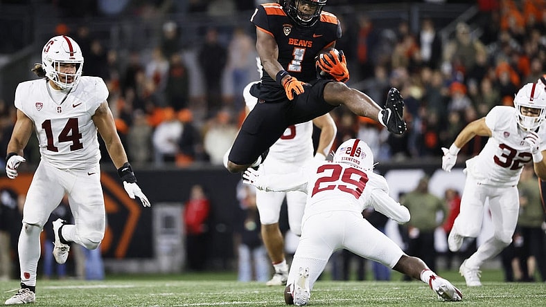 Nov 11, 2023; Corvallis, Oregon, USA; Oregon State Beavers running back Deshaun Fenwick (1) jumps over Stanford Cardinal corner back Terian Williams (29) during the second half at Reser Stadium. Mandatory Credit: Soobum Im-USA TODAY Sports