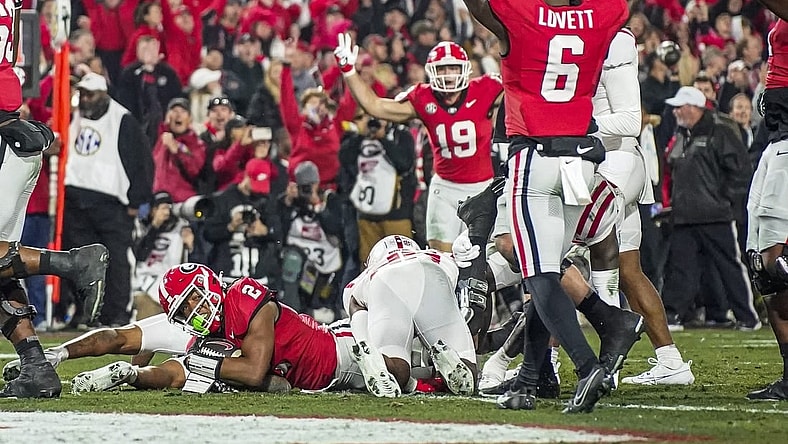 Nov 11, 2023; Athens, Georgia, USA; Georgia Bulldogs running back Kendall Milton (2) scores a touchdown against the Mississippi Rebels during the first half at Sanford Stadium. Mandatory Credit: Dale Zanine-USA TODAY Sports