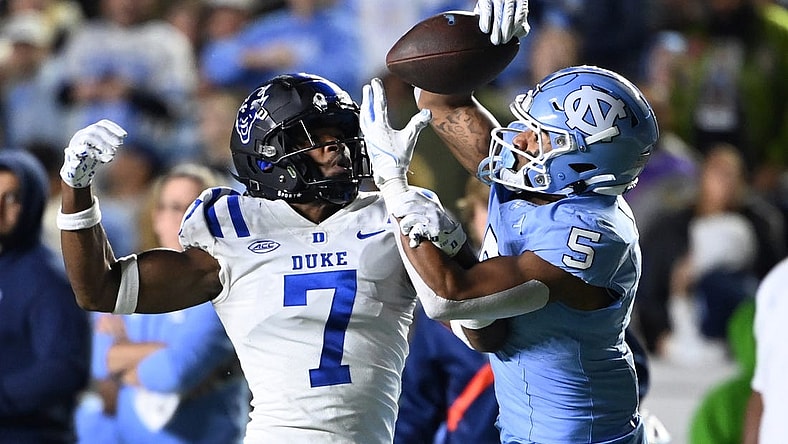 Nov 11, 2023; Chapel Hill, North Carolina, USA; North Carolina Tar Heels wide receiver J.J. Jones (5) catches the ball as Duke Blue Devils cornerback Al Blades Jr. (7) defends in the second quarter at Kenan Memorial Stadium. Mandatory Credit: Bob Donnan-USA TODAY Sports