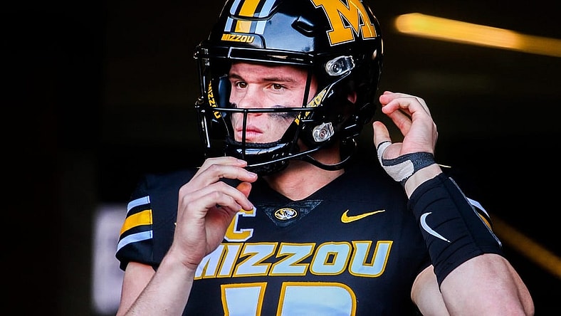 Missouri quarterback Brady Cook adjusts his helmet before a college football game at Faurot Field on Nov. 11, 2023, in Columbia, Mo.