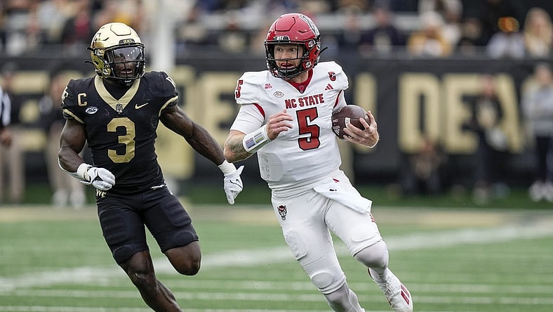 Nov 11, 2023; Winston-Salem, North Carolina, USA; Wake Forest Demon Deacons defensive back Malik Mustapha (3) chases North Carolina State Wolfpack quarterback Brennan Armstrong (5) during the first half at Allegacy Federal Credit Union Stadium. Mandatory Credit: Jim Dedmon-USA TODAY Sports