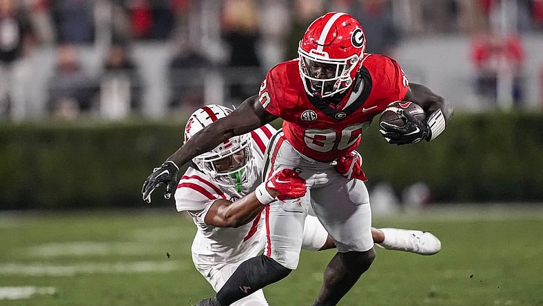 Nov 11, 2023; Athens, Georgia, USA; Georgia Bulldogs running back Daijun Edwards (30) runs against Mississippi Rebels cornerback Deantre Prince (7) during the first half at Sanford Stadium. Mandatory Credit: Dale Zanine-USA TODAY Sports