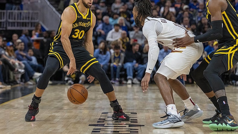 Nov 11, 2023; San Francisco, California, USA;  Golden State Warriors guard Stephen Curry (30) dribbles the basketball against Cleveland Cavaliers guard Darius Garland (10) during the fourth quarter at Chase Center. Mandatory Credit: Neville E. Guard-USA TODAY Sports