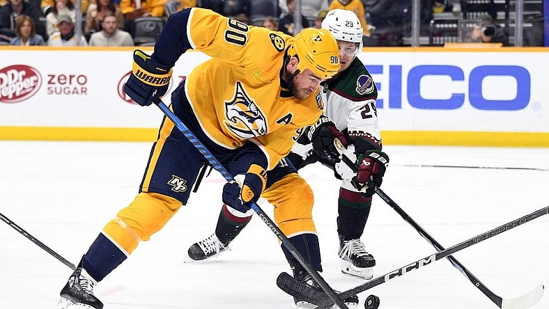 Nov 11, 2023; Nashville, Tennessee, USA; Nashville Predators center Ryan O'Reilly (90) handles the puck during the first period against the Arizona Coyotes at Bridgestone Arena. Mandatory Credit: Christopher Hanewinckel-USA TODAY Sports