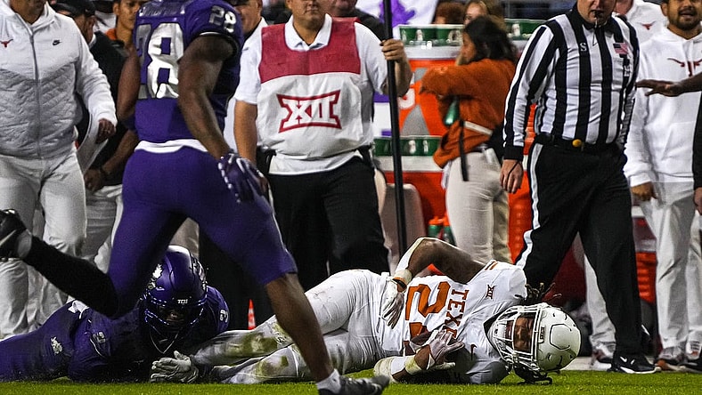 Nov 11, 2023; Fort Worth, Texas, USA; Texas Longhorns running back Jonathon Brooks (24) is brought down by TCU Horned Frogs cornerback Josh Newton (3) during the game at Amon G. Carter Stadium. Mandatory Credit: Aaron E. Martinez-USA TODAY Sports