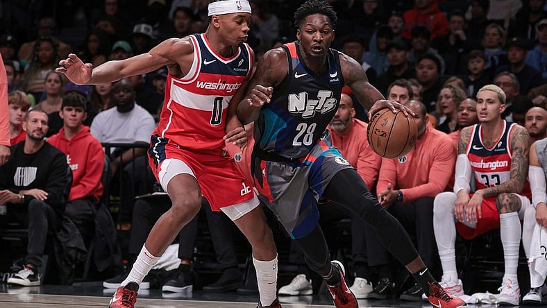 Nov 12, 2023; Brooklyn, New York, USA; Brooklyn Nets forward Dorian Finney-Smith (28) dribbles against Washington Wizards guard Bilal Coulibaly (0) during the half quarter at Barclays Center. Mandatory Credit: Vincent Carchietta-USA TODAY Sports