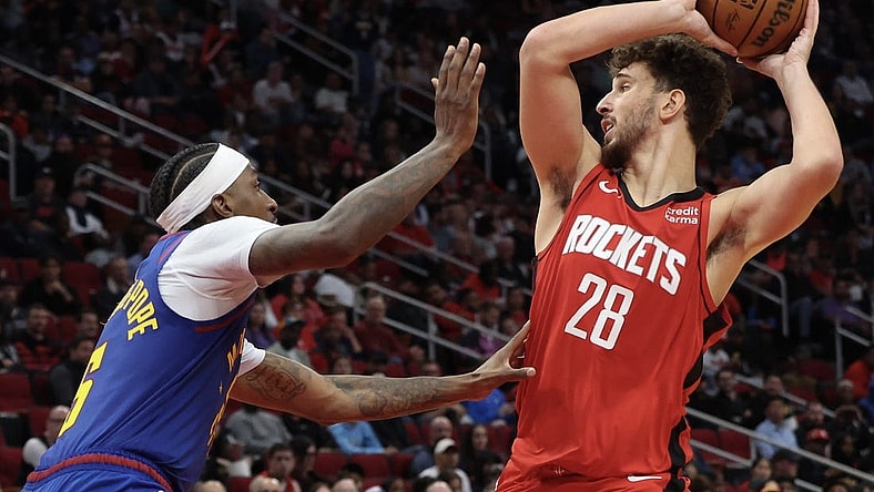 Nov 12, 2023; Houston, Texas, USA; Houston Rockets center Alperen Sengun (28) looks to pass against Denver Nuggets guard Kentavious Caldwell-Pope (5) in the second quarter at Toyota Center. Mandatory Credit: Thomas Shea-USA TODAY Sports