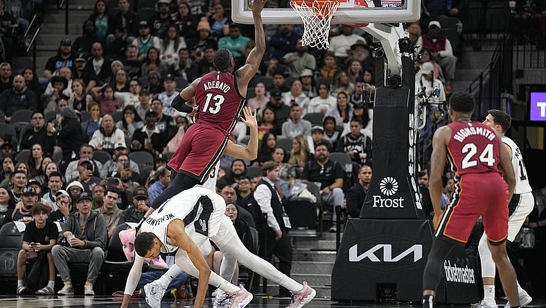 Nov 12, 2023; San Antonio, Texas, USA; Miami Heat center Bam Adebayo (13) drives to the basket past San Antonio Spurs forward Victor Wembanyama (1) during the first half at Frost Bank Center. Mandatory Credit: Scott Wachter-USA TODAY Sports