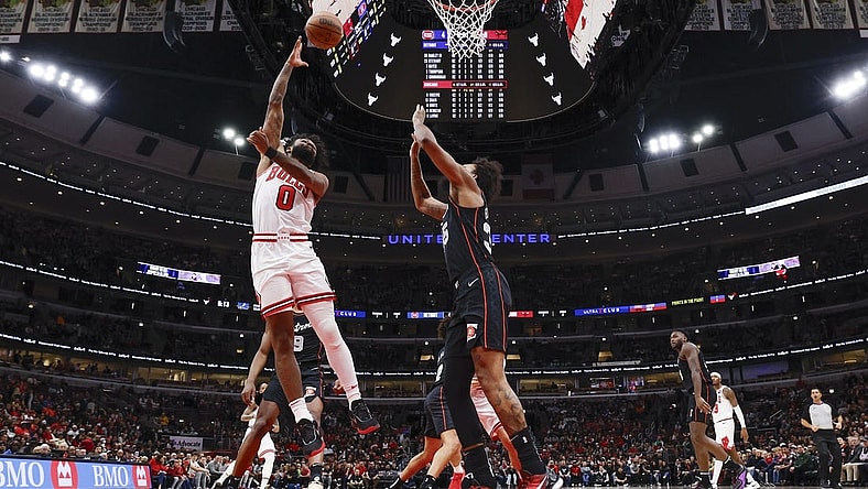 Nov 12, 2023; Chicago, Illinois, USA; Chicago Bulls guard Coby White (0) goes to the basket against Detroit Pistons forward Marvin Bagley III (35) during the first half at United Center. Mandatory Credit: Kamil Krzaczynski-USA TODAY Sports