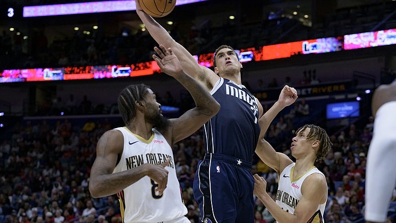 Nov 12, 2023; New Orleans, Louisiana, USA; Dallas Mavericks center Dwight Powell (7) grabs a rebound between New Orleans Pelicans forward Naji Marshall (8) and guard Dyson Daniels (11) during the first half at the Smoothie King Center. Mandatory Credit: Matthew Hinton-USA TODAY Sports