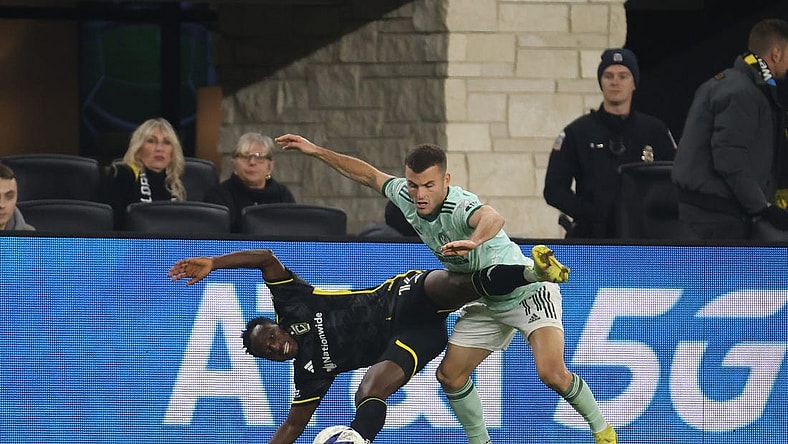 Nov 12, 2023; Columbus, Ohio, USA; Columbus Crew midfielder Yaw Yeboah (14) is challenged by Atlanta United FC defender Brooks Lennon (11) during the second half at Lower.com Field. Mandatory Credit: Trevor Ruszkowski-USA TODAY Sports