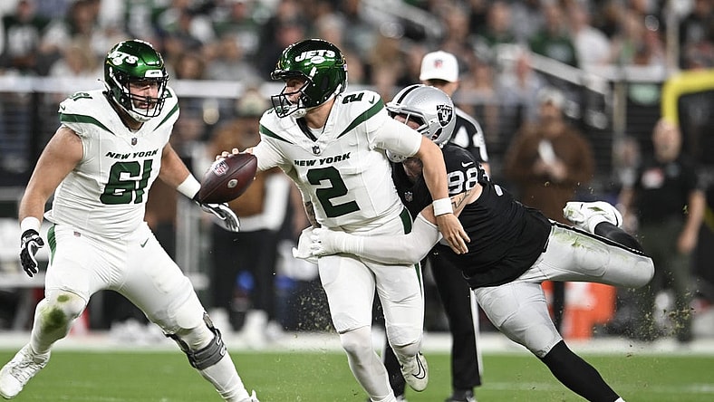 Nov 12, 2023; Paradise, Nevada, USA; New York Jets quarterback Zach Wilson (2) is tackled by Las Vegas Raiders defensive end Maxx Crosby (98) in the first quarter at Allegiant Stadium. Mandatory Credit: Candice Ward-USA TODAY Sports