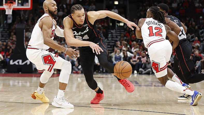 Nov 12, 2023; Chicago, Illinois, USA; Chicago Bulls guard Jevon Carter (5) defends against Detroit Pistons forward Kevin Knox II (24) during the first half at United Center. Mandatory Credit: Kamil Krzaczynski-USA TODAY Sports
