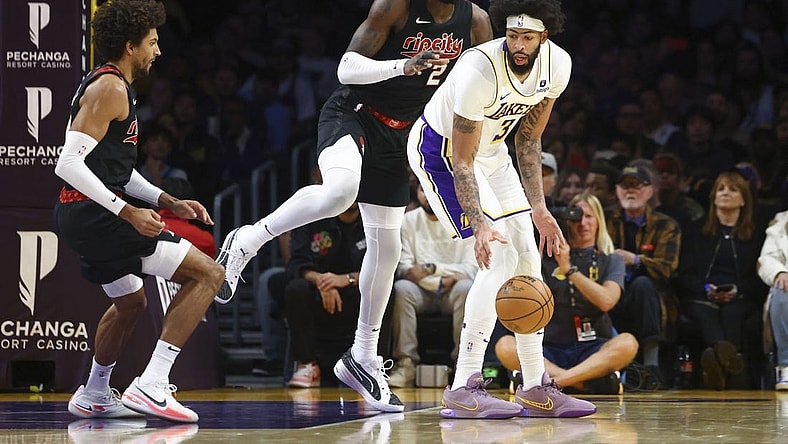 Nov 12, 2023; Los Angeles, California, USA; Los Angeles Lakers forward Anthony Davis (3) dribbles against Portland Trail Blazers center Deandre Ayton (2) during the first half of a game at Crypto.com Arena. Mandatory Credit: Jessica Alcheh-USA TODAY Sports