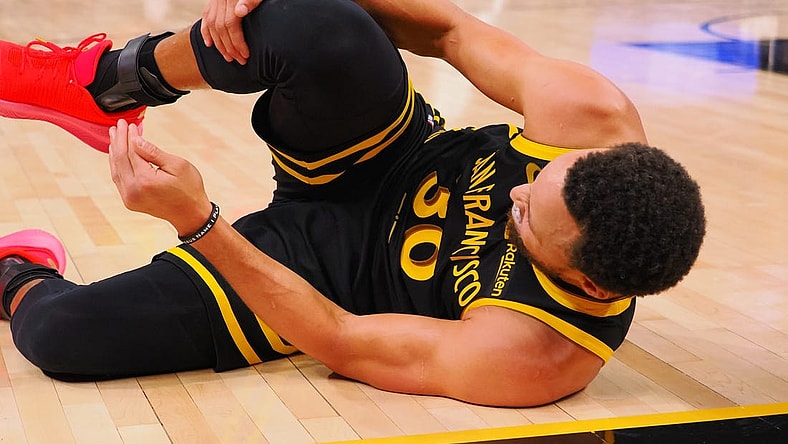 Nov 12, 2023; San Francisco, California, USA; Golden State Warriors guard Stephen Curry (30) holds his leg as he goes down on the floor during the fourth quarter against the Minnesota Timberwolves at Chase Center. Mandatory Credit: Kelley L Cox-USA TODAY Sports