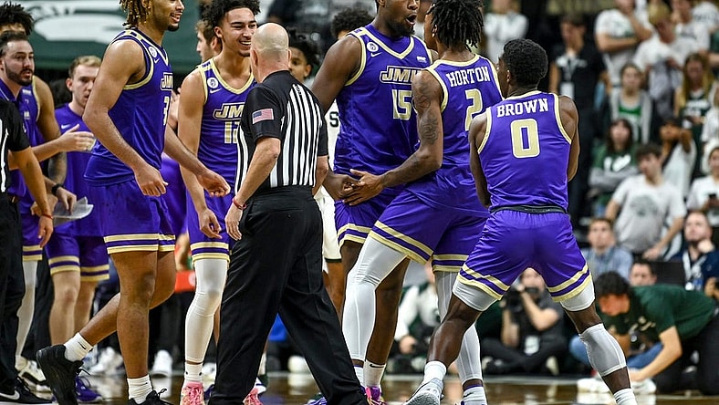James Madison celebrates after Raekwon Horton (2) made a 3-pointer against Michigan State during overtime on Monday, Nov. 6, 2023, in East Lansing.