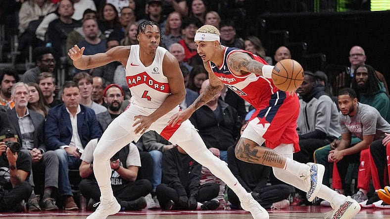 Nov 13, 2023; Toronto, Ontario, CAN; Washington Wizards forward Kyle Kuzma (33) controls the ball as Toronto Raptors forward Scottie Barnes (4) defends during the first quarter at Scotiabank Arena. Mandatory Credit: Nick Turchiaro-USA TODAY Sports