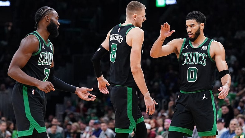 Nov 13, 2023; Boston, Massachusetts, USA; Boston Celtics forward Jayson Tatum (0), center Kristaps Porzingis (8) and guard Jaylen Brown (7) react after a play against th eNew York Knicks in the second quarter at TD Garden. Mandatory Credit: David Butler II-USA TODAY Sports