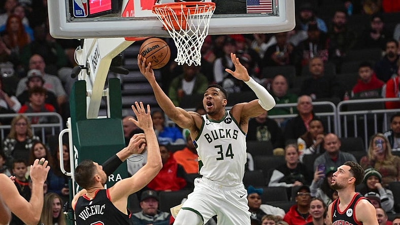 Nov 13, 2023; Milwaukee, Wisconsin, USA; Milwaukee Bucks forward Giannis Antetokounmpo (34) takes a shot against Chicago Bulls center Nikola Vucevic (9) in the first quarter at Fiserv Forum. Mandatory Credit: Benny Sieu-USA TODAY Sports