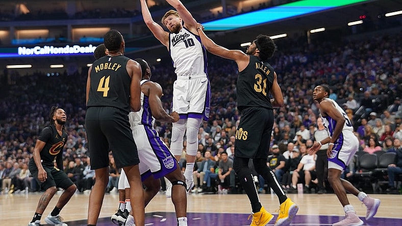 Nov 13, 2023; Sacramento, California, USA; Sacramento Kings forward Domantas Sabonis (10) grabs a rebound next to Cleveland Cavaliers center Jarrett Allen (31) in the first quarter at the Golden 1 Center. Mandatory Credit: Cary Edmondson-USA TODAY Sports