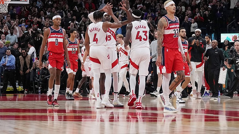 Nov 13, 2023; Toronto, Ontario, CAN; Toronto Raptors forward Pascal Siakam (43), forward Scottie Barnes (4), and forward Chris Boucher (25) celebrate a basket against the Washington Wizards during the fourth quarter at Scotiabank Arena. Mandatory Credit: Nick Turchiaro-USA TODAY Sports