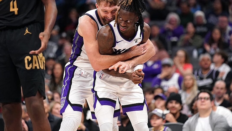 Nov 13, 2023; Sacramento, California, USA; Sacramento Kings forward Domantas Sabonis (10) hugs guard Keon Ellis (23) after Sabonis made a basket while being fouled against the Cleveland Cavaliers in the fourth quarter at the Golden 1 Center. Mandatory Credit: Cary Edmondson-USA TODAY Sports