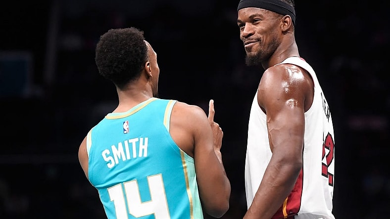 Nov 14, 2023; Charlotte, North Carolina, USA;  Miami Heat forward Jimmy Butler (22) talks to Charlotte Hornets guard Ish Smith (14) during a time out during the first half at the Spectrum Center. Mandatory Credit: Sam Sharpe-USA TODAY Sports