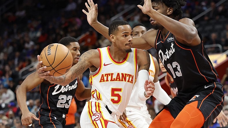 Nov 14, 2023; Detroit, Michigan, USA; Atlanta Hawks guard Dejounte Murray (5) dribbles defended by Detroit Pistons center James Wiseman (13) in the first half at Little Caesars Arena. Mandatory Credit: Rick Osentoski-USA TODAY Sports
