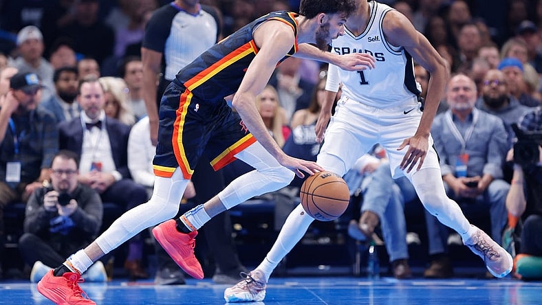 Nov 14, 2023; Oklahoma City, Oklahoma, USA; Oklahoma City Thunder forward Chet Holmgren (7) drives past San Antonio Spurs center Victor Wembanyama (1) during the second quarter at Paycom Center. Mandatory Credit: Alonzo Adams-USA TODAY Sports