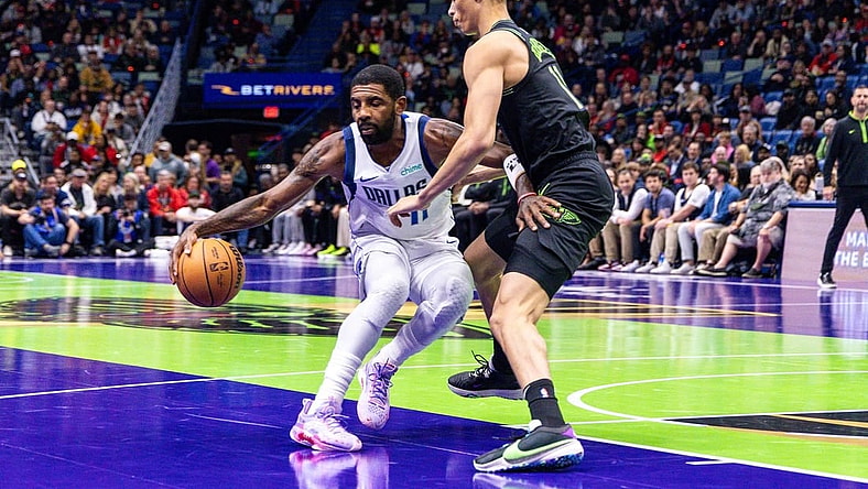 Nov 14, 2023; New Orleans, Louisiana, USA;  Dallas Mavericks guard Kyrie Irving (11) dribbles around New Orleans Pelicans guard Dyson Daniels (11) during the first half at the Smoothie King Center. Mandatory Credit: Stephen Lew-USA TODAY Sports