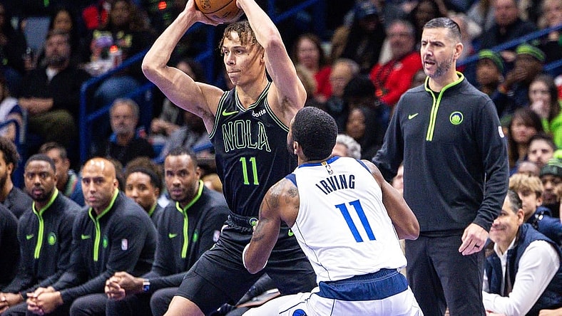 Nov 14, 2023; New Orleans, Louisiana, USA;  New Orleans Pelicans guard Dyson Daniels (11) looks to pass the ball against Dallas Mavericks guard Kyrie Irving (11) with acting head coach James Borrego looks on during the first half at the Smoothie King Center. Mandatory Credit: Stephen Lew-USA TODAY Sports