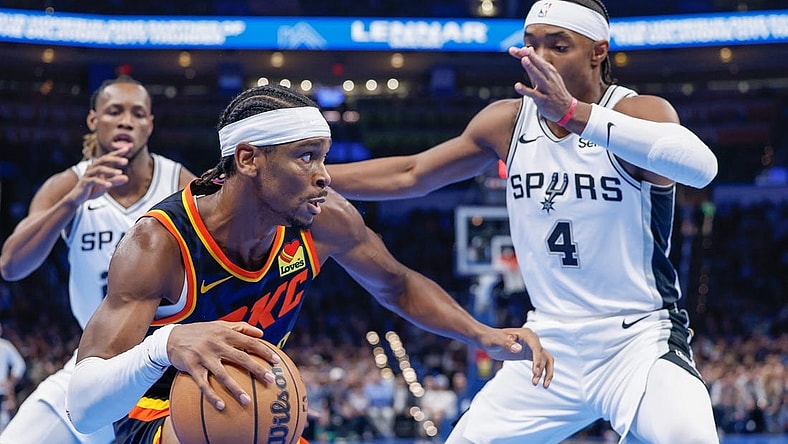 Nov 14, 2023; Oklahoma City, Oklahoma, USA; Oklahoma City Thunder guard Shai Gilgeous-Alexander (2) drives against San Antonio Spurs guard Devonte' Graham (4) during the second half at Paycom Center. Mandatory Credit: Alonzo Adams-USA TODAY Sports