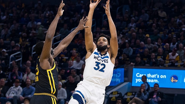 Nov 14, 2023; San Francisco, California, USA; Golden State Warriors forward Draymond Green (23) defends Minnesota Timberwolves forward Karl-Anthony Towns (32) during the first half at Chase Center. Mandatory Credit: John Hefti-USA TODAY Sports