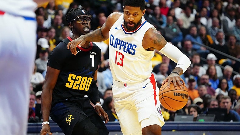 Nov 14, 2023; Denver, Colorado, USA;  LA Clippers forward Paul George (13) drives to the basket against Denver Nuggets guard Reggie Jackson (7) in the second quarter at Ball Arena. Mandatory Credit: Ron Chenoy-USA TODAY Sports