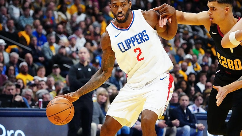 Nov 14, 2023; Denver, Colorado, USA; LA Clippers forward Kawhi Leonard (2) drives to the basket against Denver Nuggets forward Michael Porter Jr. (1) in the second quarter at Ball Arena. Mandatory Credit: Ron Chenoy-USA TODAY Sports