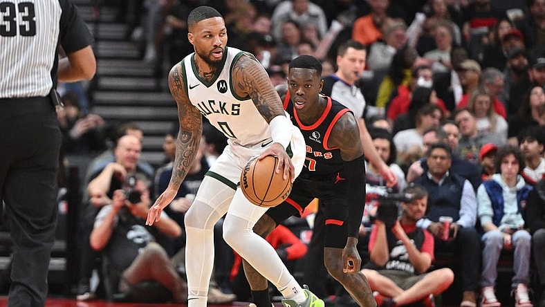 Nov 15, 2023; Toronto, Ontario, CAN;  Milwaukee Bucks guard Damian Lillard (0) controls the ball as Toronto Raptors guard Dennis Schroder (17) defends in the first half at Scotiabank Arena. Mandatory Credit: Dan Hamilton-USA TODAY Sports