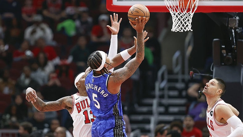 Nov 15, 2023; Chicago, Illinois, USA; Orlando Magic forward Paolo Banchero (5) shoots against Chicago Bulls forward Torrey Craig (13) during the first half at United Center. Mandatory Credit: Kamil Krzaczynski-USA TODAY Sports