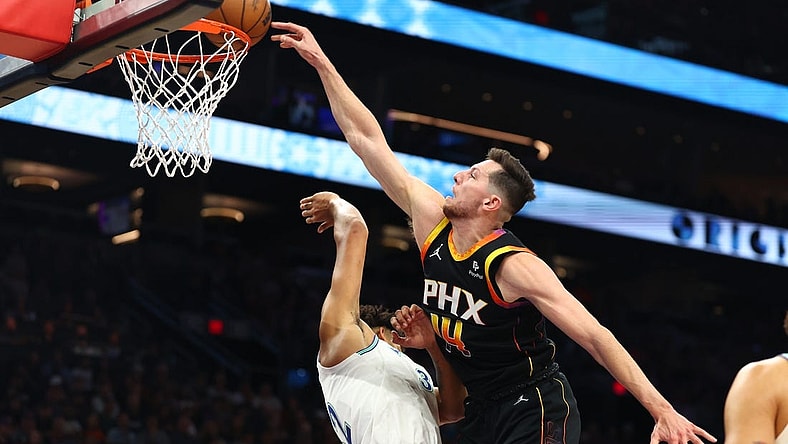 Nov 15, 2023; Phoenix, Arizona, USA; Phoenix Suns forward Drew Eubanks (right) slam dunks the ball against Minnesota Timberwolves center Karl-Anthony Towns in the first half at Footprint Center. Mandatory Credit: Mark J. Rebilas-USA TODAY Sports